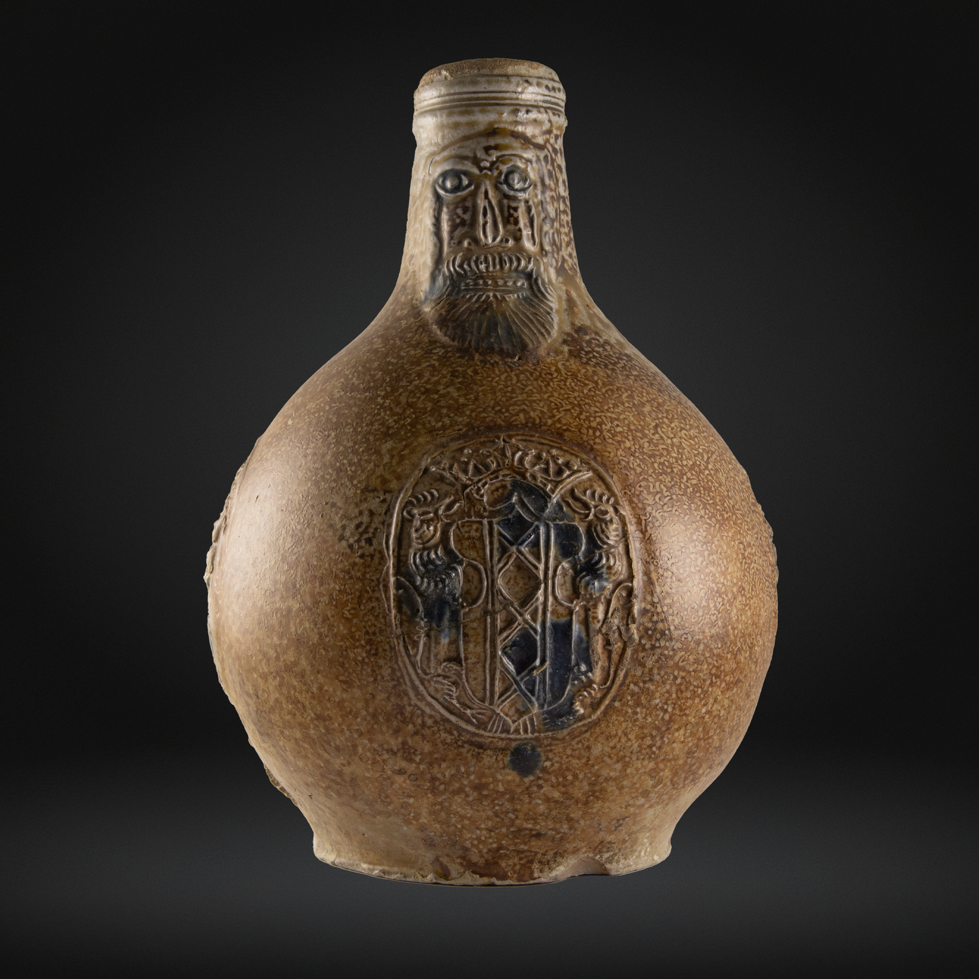 Cobalt Splashed Bellarmine Bottle, 3 Medallion, Amsterdam Coat of Arms 16th / 17th Century with detailed carved face and ornate medallions on antique stoneware surface.