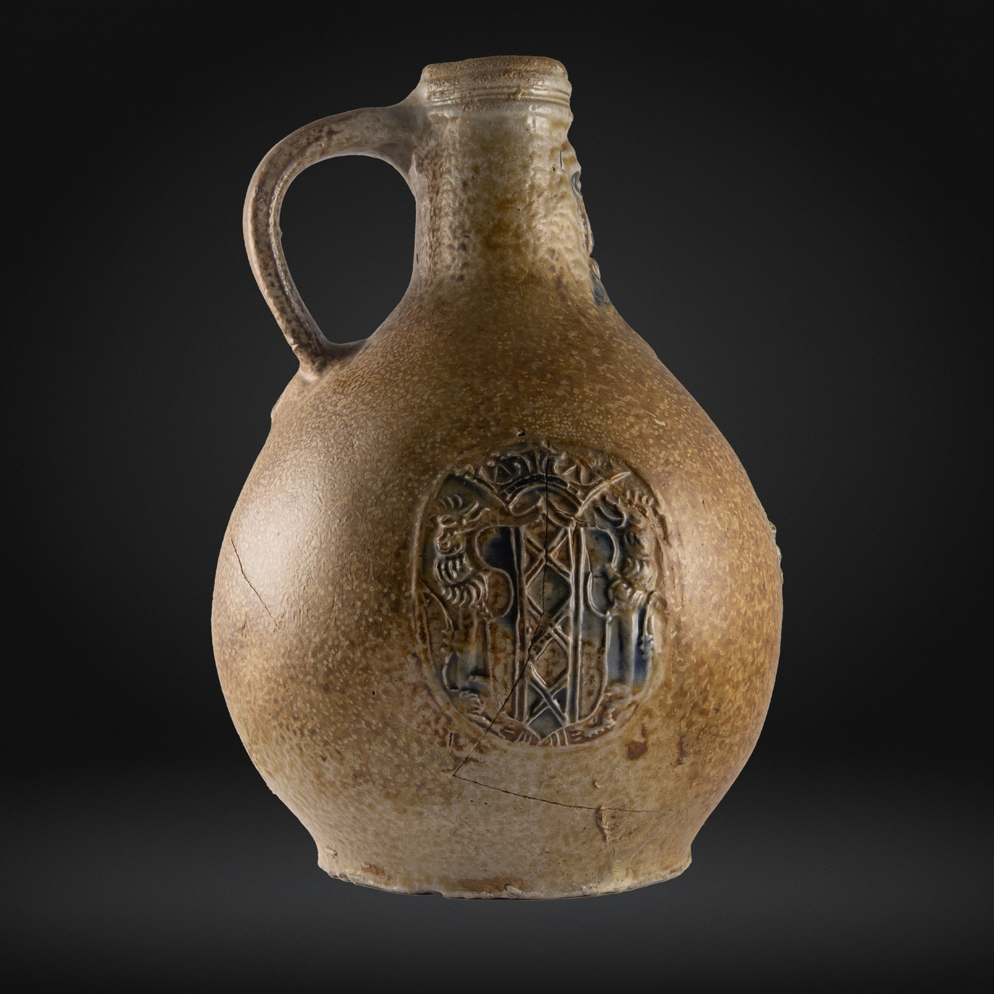 16th century ceramic jug with decorative emblem of the Amsterdam coat of arms.