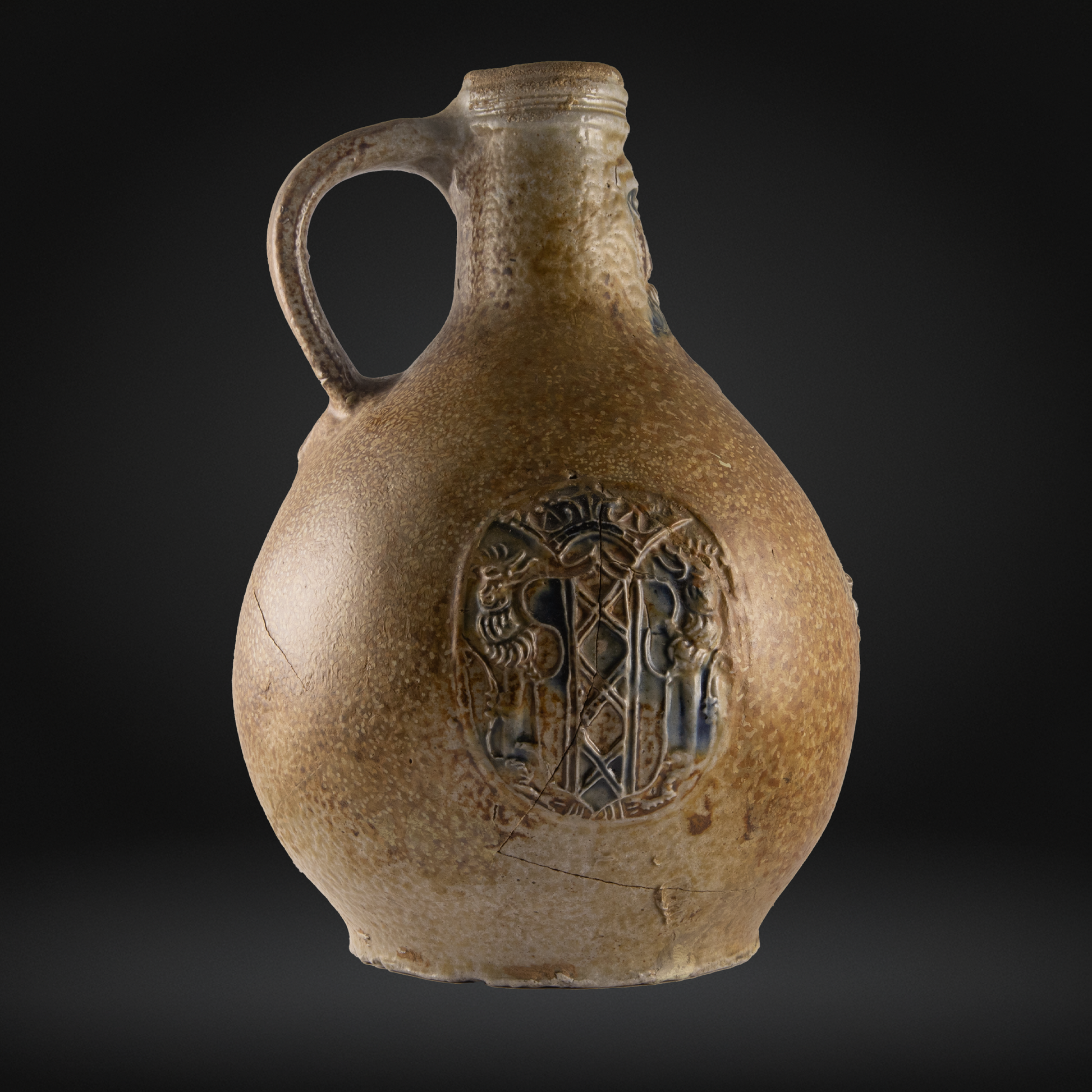 16th century ceramic jug with decorative emblem of the Amsterdam coat of arms.