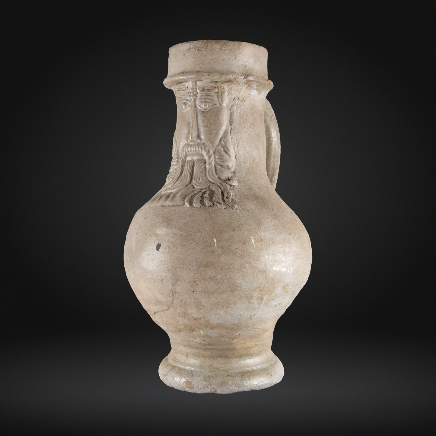 16th Century Raeren Salt Glaze Stoneware Bellarmine Jug featuring a detailed bearded face with a hat, representing antique German stoneware pottery with salt glaze finish.