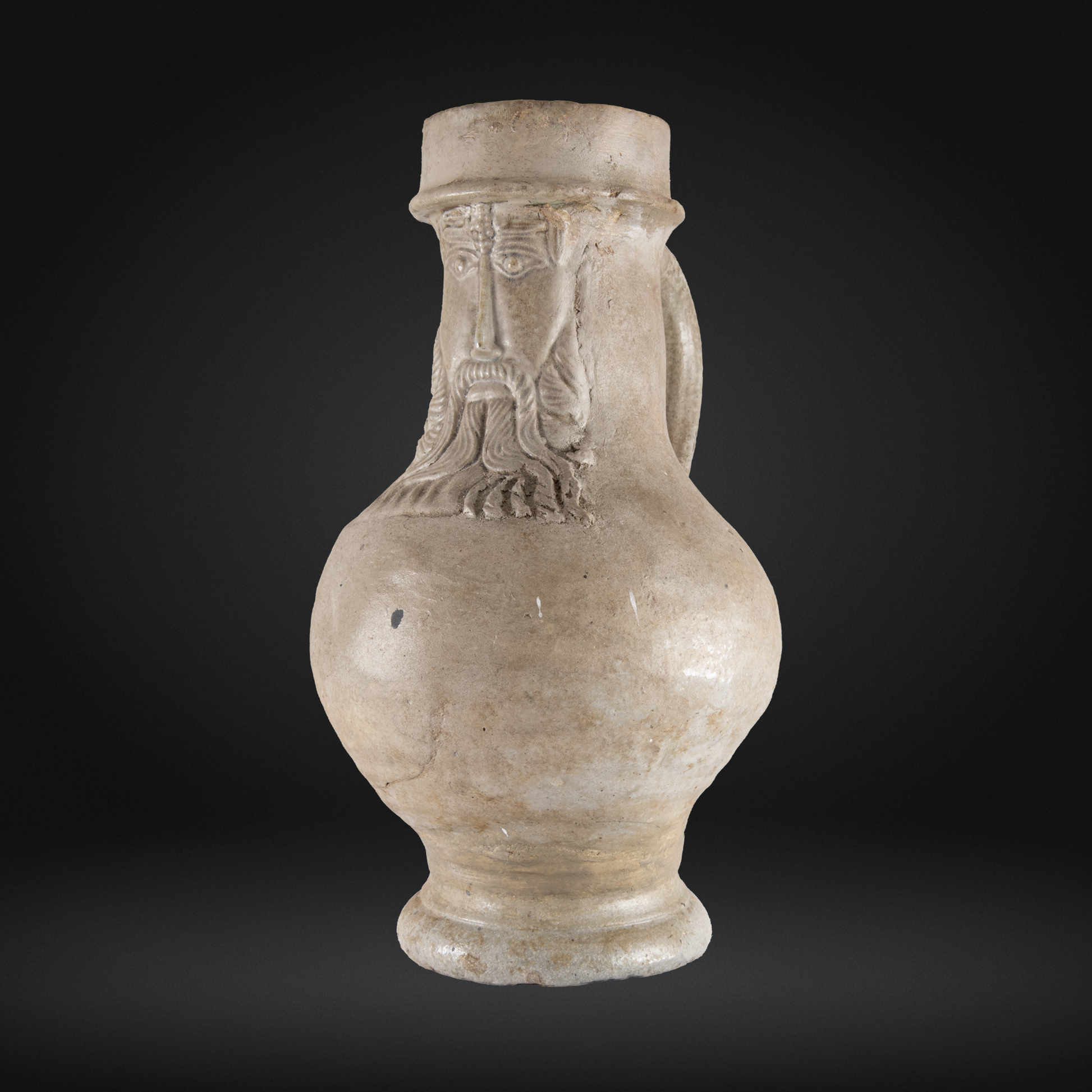 16th Century Raeren Salt Glaze Stoneware Bellarmine Jug featuring a detailed bearded face with a hat, representing antique German stoneware pottery with salt glaze finish.
