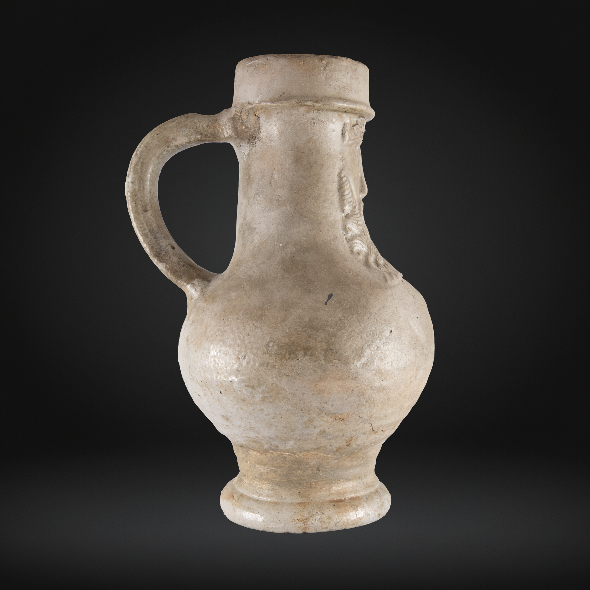 16th Century Raeren Salt Glaze Stoneware Bellarmine Jug with a bulbous body, sturdy handle, and subtle relief decoration typical of antique German stoneware.