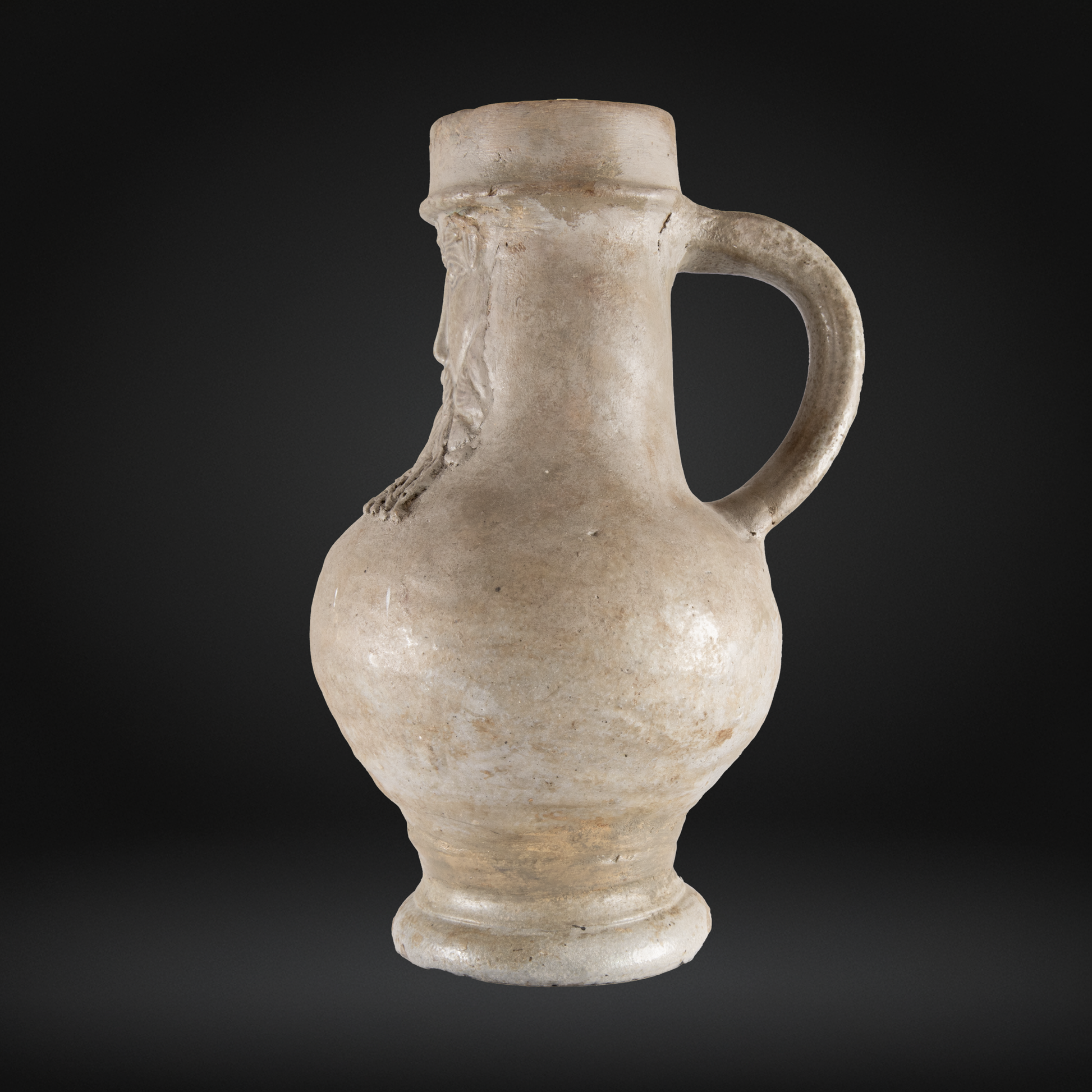 16th Century Raeren Salt Glaze Stoneware Bellarmine Jug in muted beige tones with a rounded body, sturdy handle, and characteristic medieval German stoneware style.