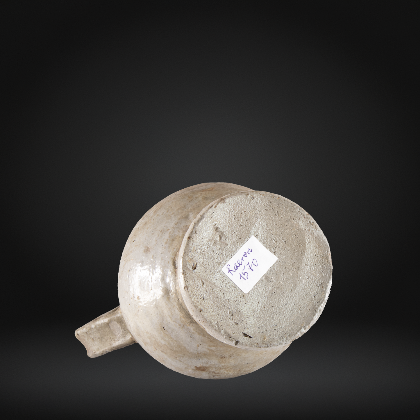 Base view of a 16th Century Raeren Salt Glaze Stoneware Bellarmine Jug showing its textured bottom and worn salt glaze finish.