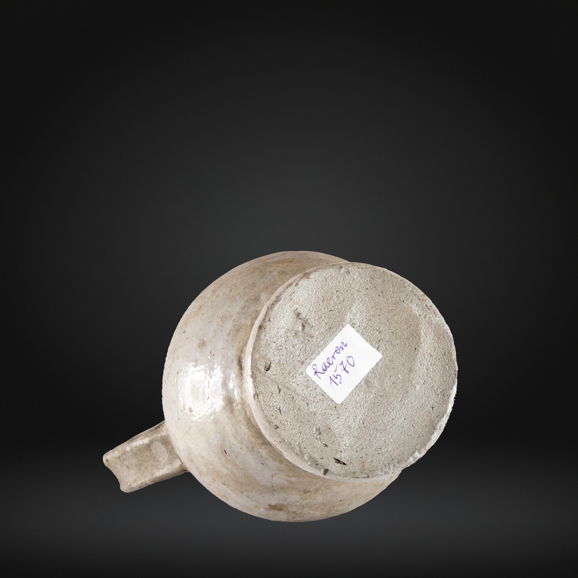 Base view of a 16th Century Raeren Salt Glaze Stoneware Bellarmine Jug showing its textured bottom and worn salt glaze finish.