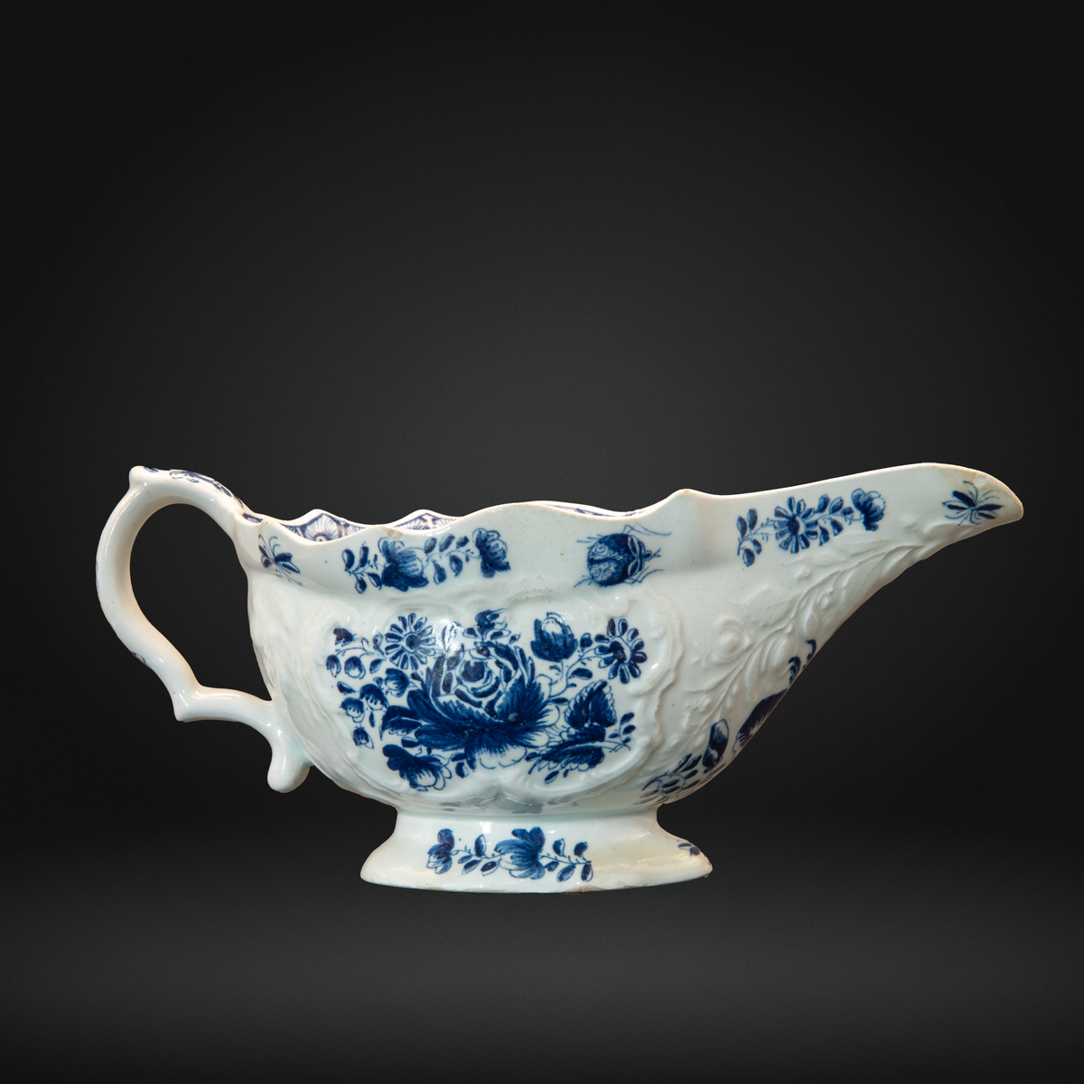 18th century bow moulded porcelain sauceboat decorated in underglaze blue