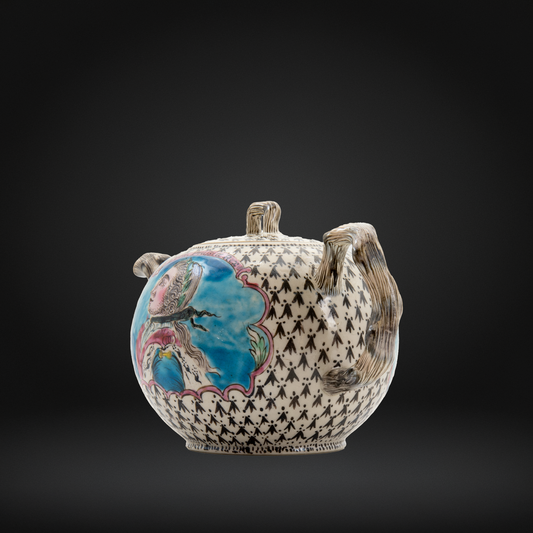 A decorative ceramic teapot with a black and white geometric patterned body, a colorful hand-painted bird illustration on the side, and two sculpted handles that resemble tree trunks, set against a dark gray gradient background.