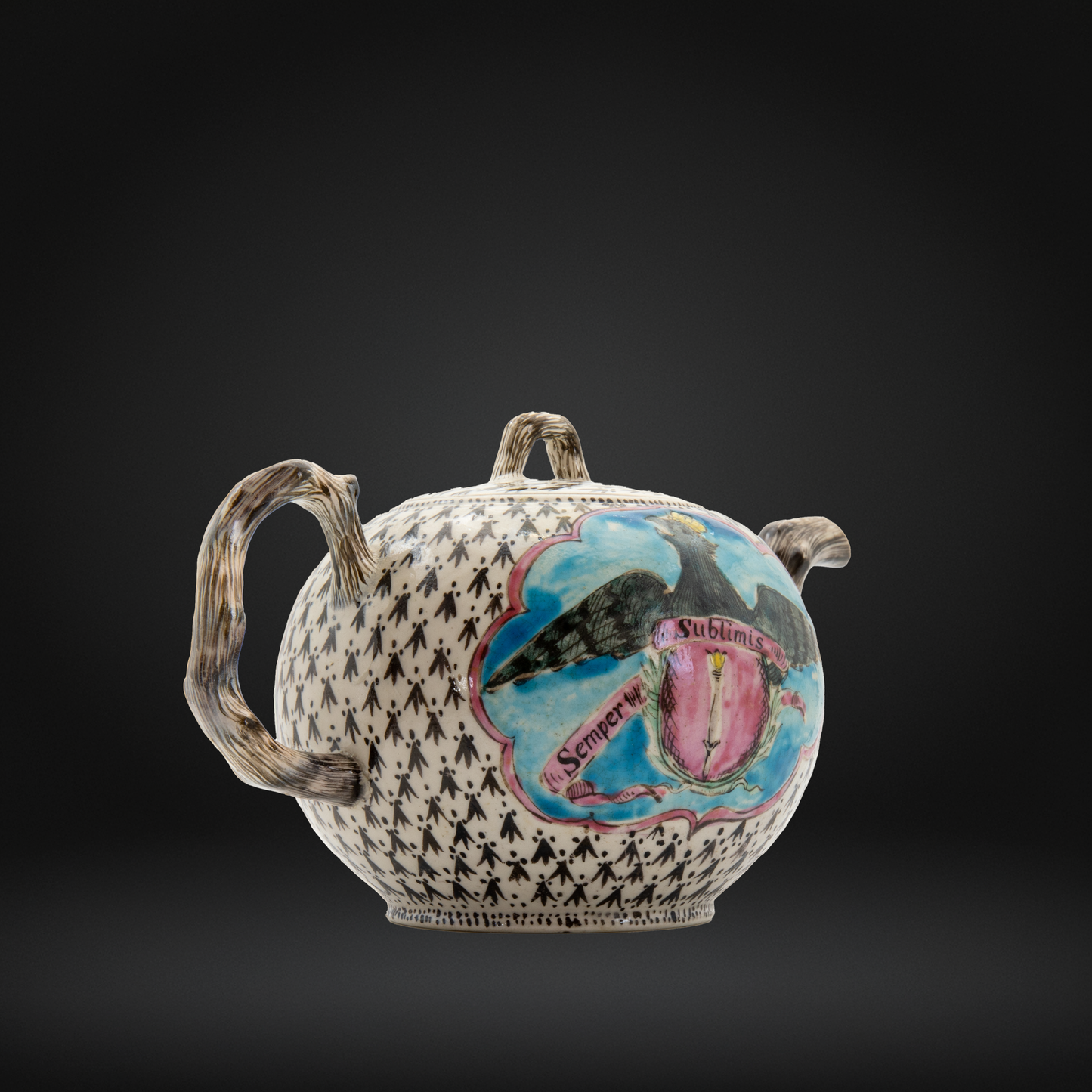 A decorative ceramic teapot with a black and white houndstooth pattern, a textured brown handle, and a colorful central illustration featuring a crowned eagle.