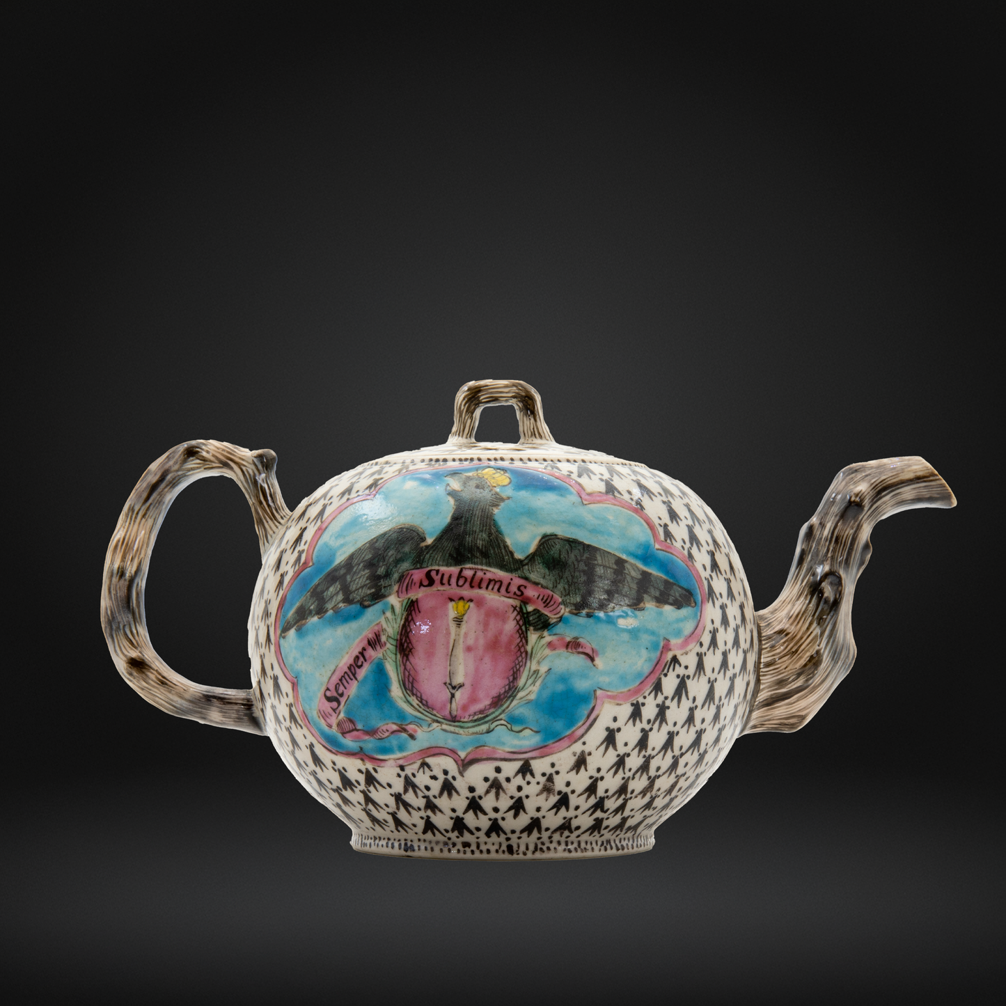 An 18th century Staffordshire salt glazed teapot decorated in enamels for a crowned eagle inscribed Semper Sublimis over a blue ground.