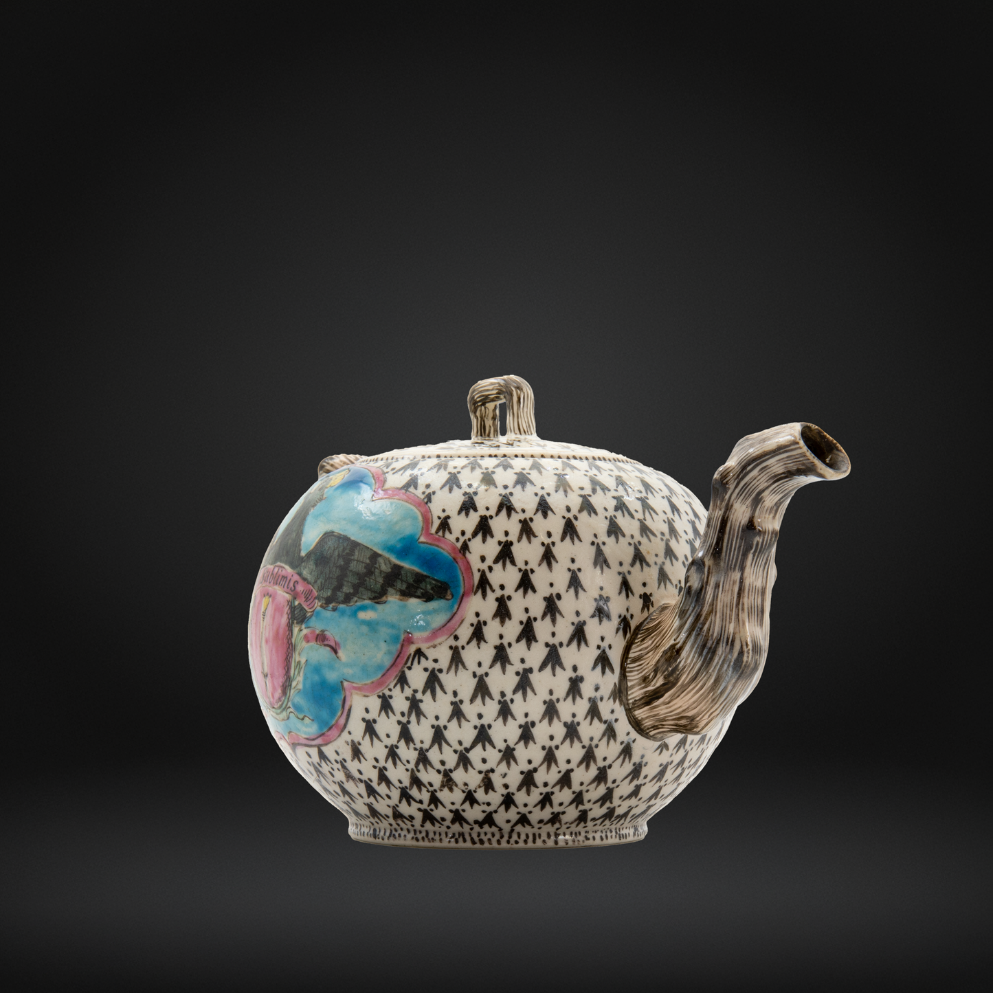 A ceramic teapot with a black and white geometric pattern, a textured brown spout, and a colorful hand-painted floral motif on the side, set against a dark gray gradient background.