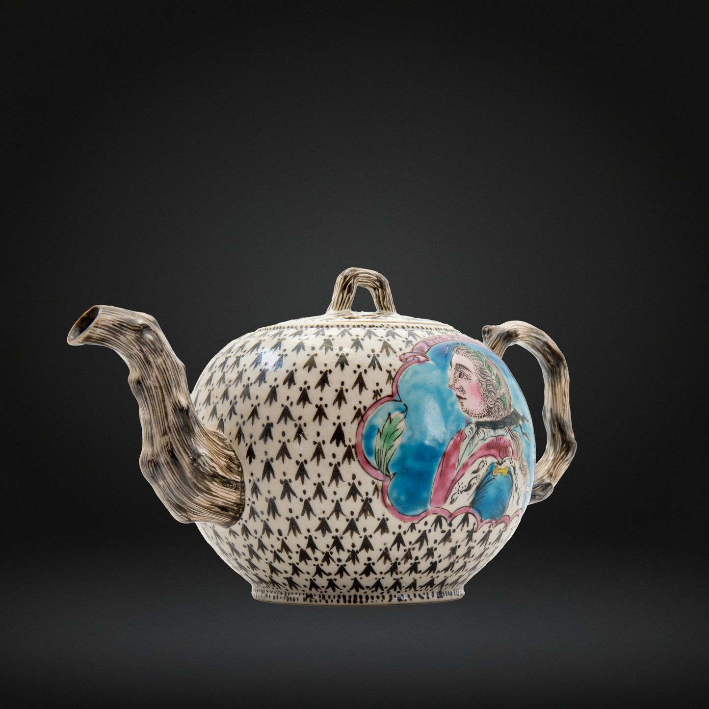 An ornate ceramic teapot with a black and white patterned body, textured brown handles and spout, and a colorful hand-painted portrait on the side, set against a dark gradient background.
